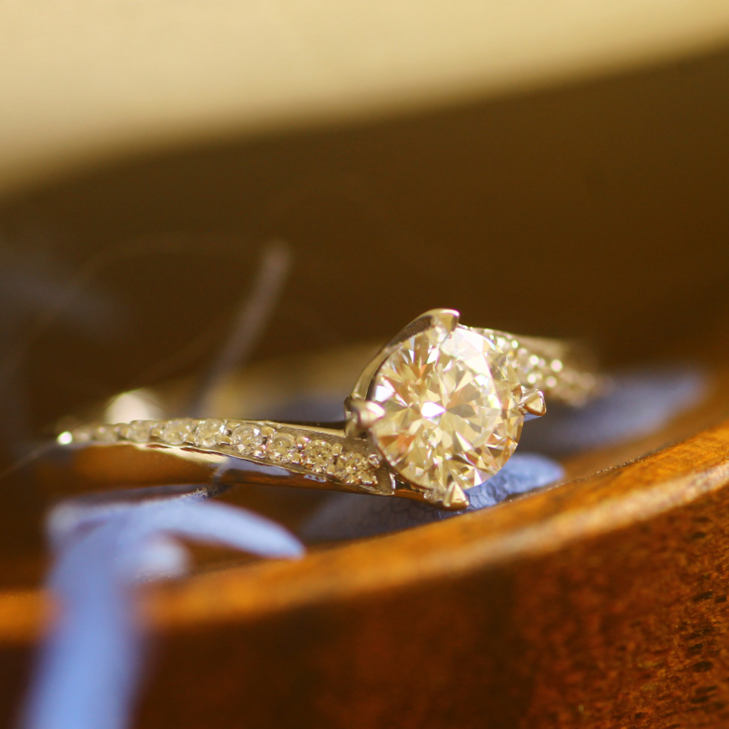 Diamond engagement ring on wood surface