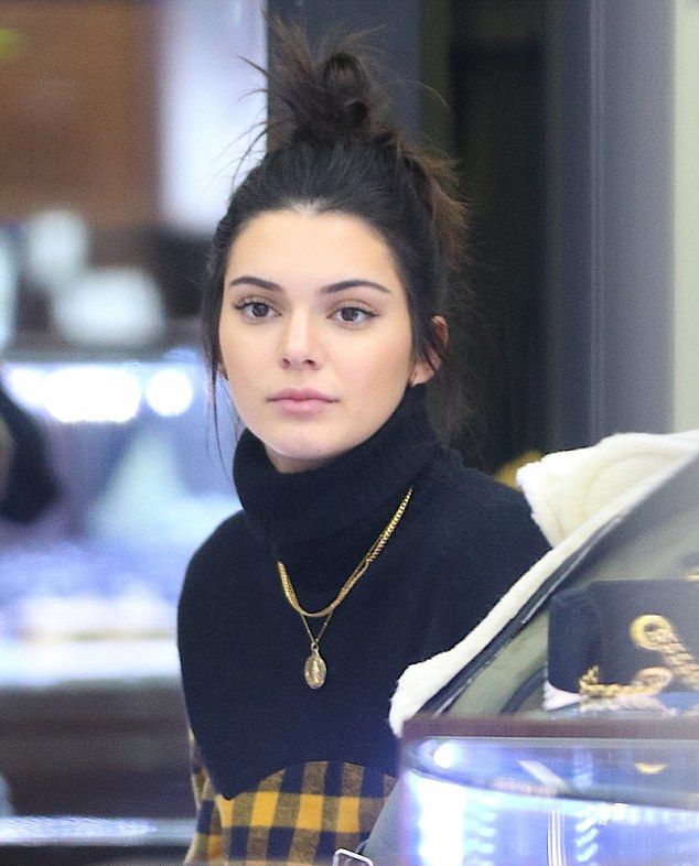 Kendall Jenner: As a top model, Kendall Jenner is often seen wearing high neck dresses with layered chains and small hoop earrings