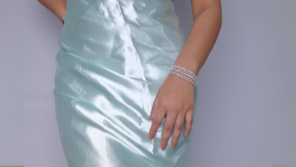 Woman in satin dress with diamond bracelet