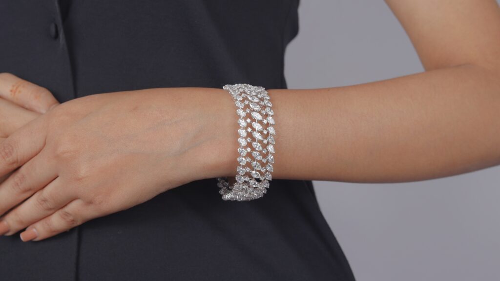 Woman wearing diamond bracelet on wrist.